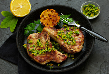 Pork cutlet on a bone with gremolat sauce.