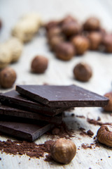 Pile of dark chocolate with nuts and nutshells