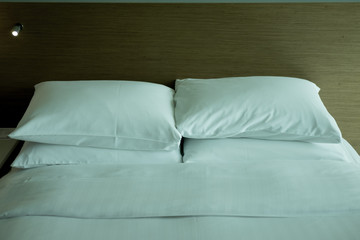Fototapeta na wymiar White bedding sheets and pillow