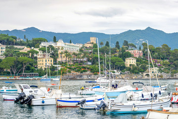 Fototapeta na wymiar Daylight view to port full of parked boats. Santa Margherita Ligure, Italy. Cinque Terre