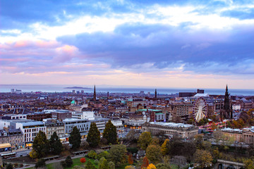 Fototapeta na wymiar Vibrant Sunset view of Edinburgh Scotland with autumn leaves.