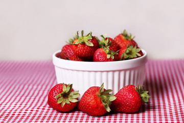  Fresh Strawberries in White Bowl on Red Gingham Tablecloth