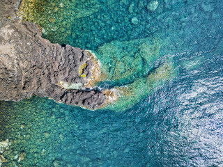 Aerial view of a lava formation in the crystal blue waters near the town of Canada de Africa in Sao Jorge, Portugal.
