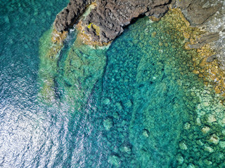 Aerial shot of a lava formation and the beautiful blue waters of the atlantic near Canada de Africa on Sao Jorge in the Azores. © Danaan