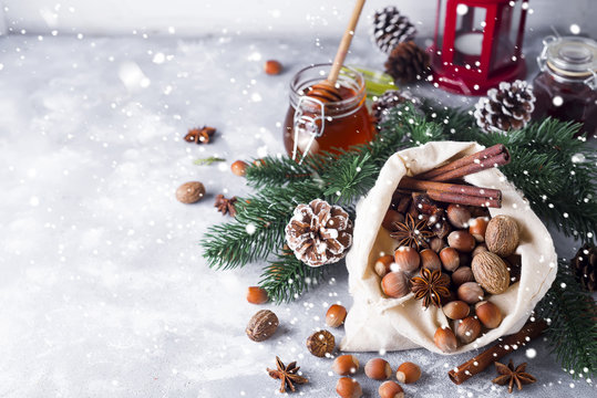 Festive christmas nuts and spices tumbling from a burlap bag