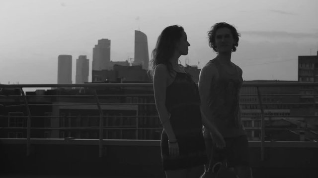 Silhouettes of young couple dancing on sunset