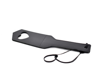 Sex spanking paddle with heart shape stock photo images. Leather slap on a white background. BDSM...