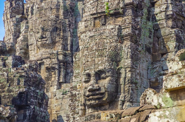 Serene and smiling stone-faces on the towers of Bayon Temple. Angkor - UNESCO World Heritage site. Cambodia, Siem Reap, Angkor Thom