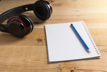 Blank notebook with pencil on wooden table, business concept