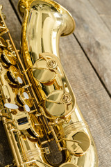 Beautiful golden saxophone on wooden background
