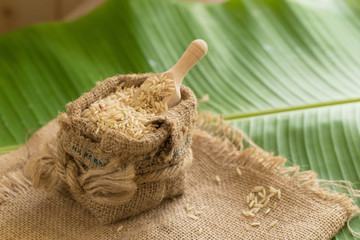 Brown rice in sacks on banana leaves