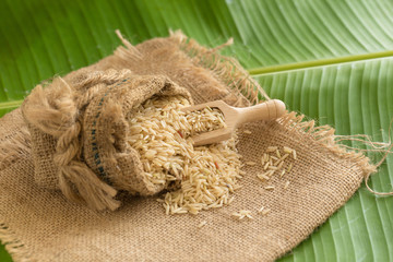 Brown rice in sacks on banana leaves