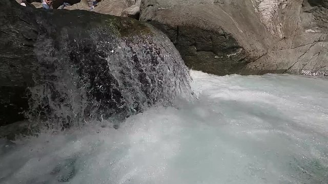 Water in a mountain river in slow motion video.