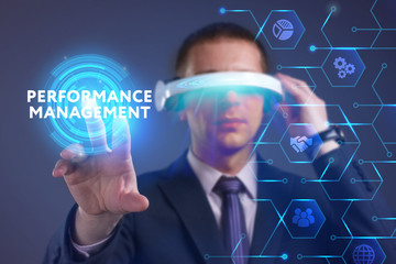 Business, Technology, Internet and network concept. Young businessman working on a virtual screen of the future and sees the inscription: Performance management