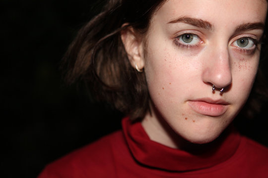 Teenage Girl With Septum Piercing Looking Somber