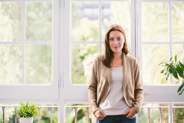 Portrait of a mature woman standing at home.