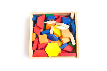 Fototapeta na wymiar Wooden multi-colored blocks in a wooden box on a white background