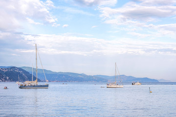 Fototapeta premium Daylight beautiful view to ships cruising on water and blue sky. Santa Margherita Ligure, Italy