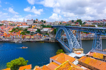 View over the old town of Porto, Portugal with the cathedral, Ponte de Dom Luis I, Clerigos tower (Torre dos Clerigos) and colorful buildings at Cais da Ribeira with Duoro river - obrazy, fototapety, plakaty
