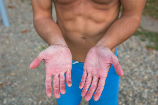 Sportive man's wounded hands after intense training