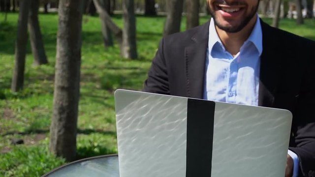 Gigolo texting with new lady in Internet by laptop.