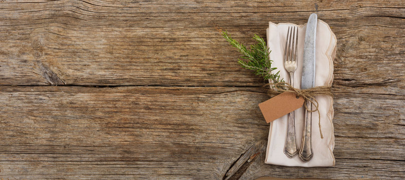 Table setting with tag on wooden background