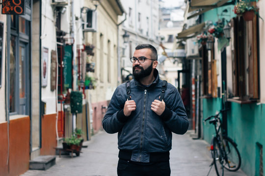 Portrait of a male model with glasses on the street