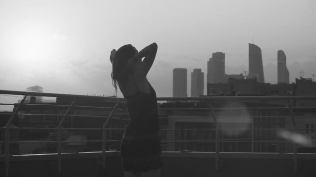 Silhouettes of young couple dancing on sunset