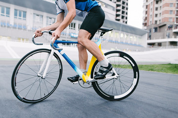 Fototapeta premium A man rides a bike on a fixed track. Bicycle close up.