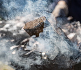 White thick smoke from smoldering firewood close-up