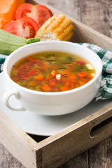 Vegetable soup in bowl on wooden table

