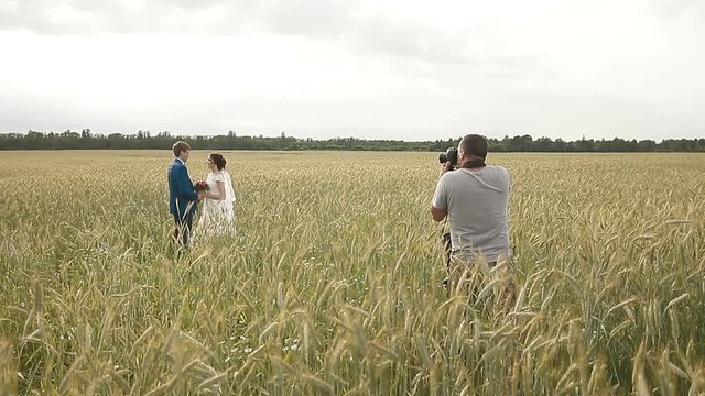 Photographer taking pictures couple of newlyweds