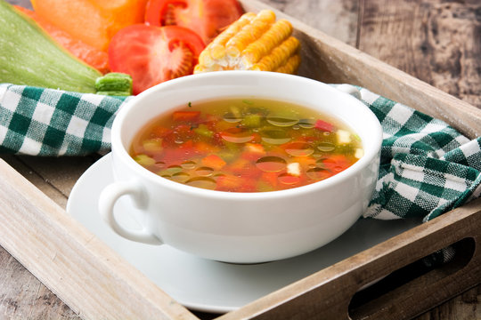 Vegetable soup in bowl on wooden table
