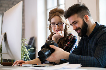 Picture of young attractive designers looking at camera