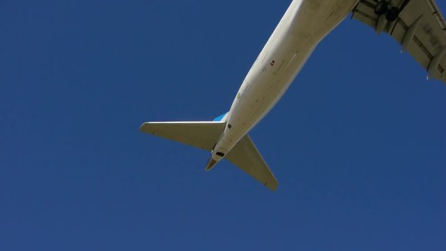 Plane passing by and about to Land. Over blue sky. day.