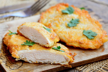 Easy fried chicken chops photo. Fried chicken chops on a cutting board. Rustic style. Closeup