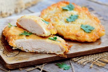Fried chicken chop. Home fried chicken chop on a wooden board. Rustic style. Closeup