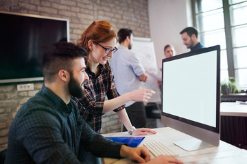 Portrait of young designers working on computer