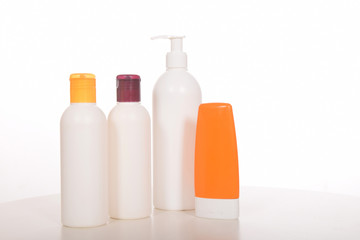 Cosmetics in bottles of plastic containers and tubes