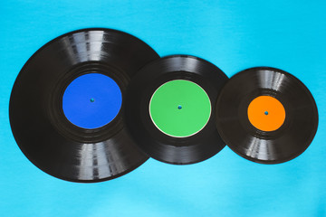 Old vintage vinyl records on the blue background.
