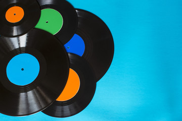 Old vintage vinyl records on the blue background. Copy space.