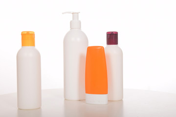 Cosmetics in bottles of plastic containers and tubes