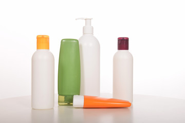 Cosmetics in bottles of plastic containers and tubes