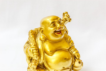 Laughing Buddha painted in gold colour with white backdrop