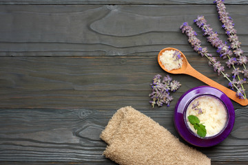 Plakat spa background. sea salt in bowl with lavenders on dark wooden background. top view with copy space. 