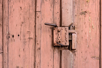 Old Door Handle. Old wooden door with iron handle on the church.