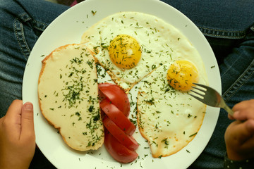 the child is sitting and eating lunch