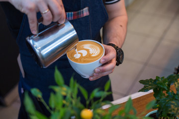 Barista prepares cappuccino