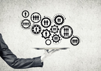Waiter hand with white gloves holding silver plate full of social media communication icons
