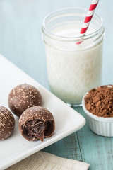 Chocolate Truffles on a Tray With Milk and Cocoa Powder